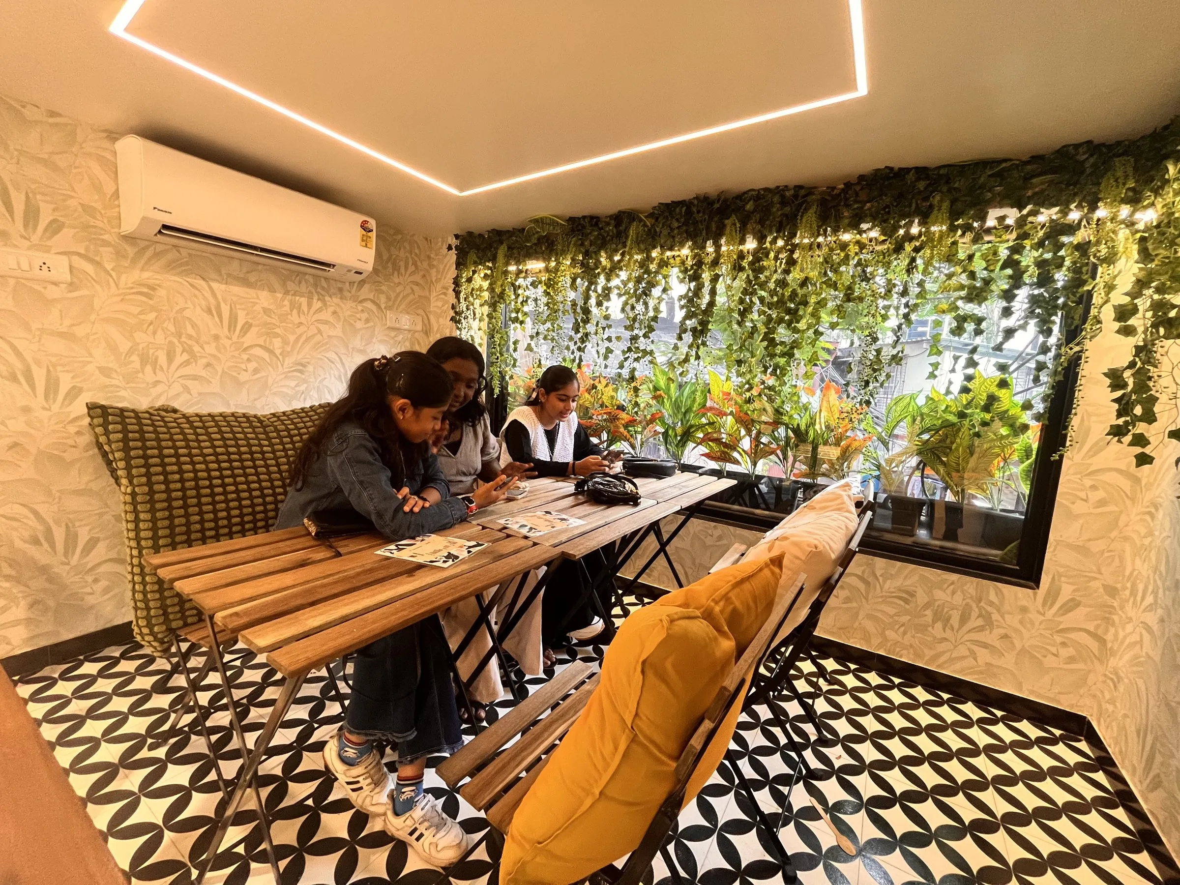 The café after: planted wall, patterned floor and timber seating